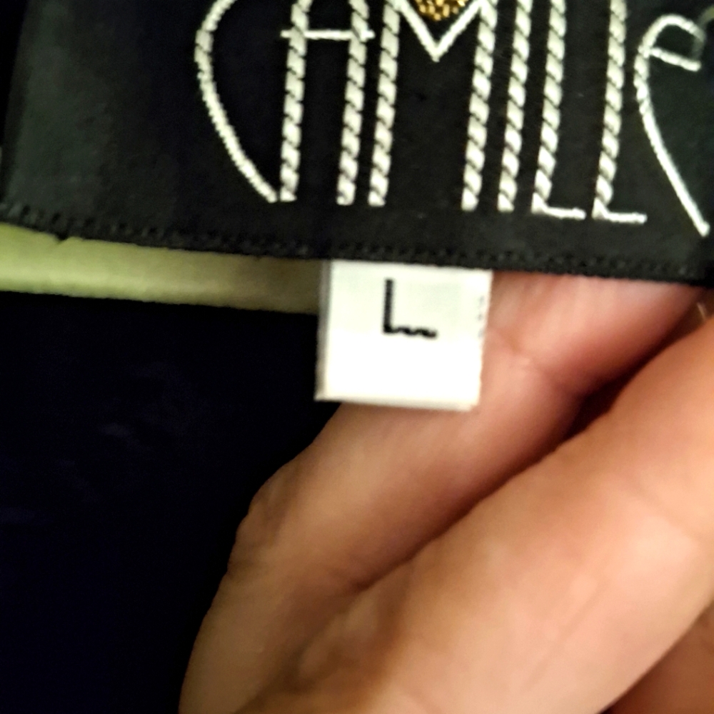 Camille Black jaclet lave sleeves amd embellishments.
